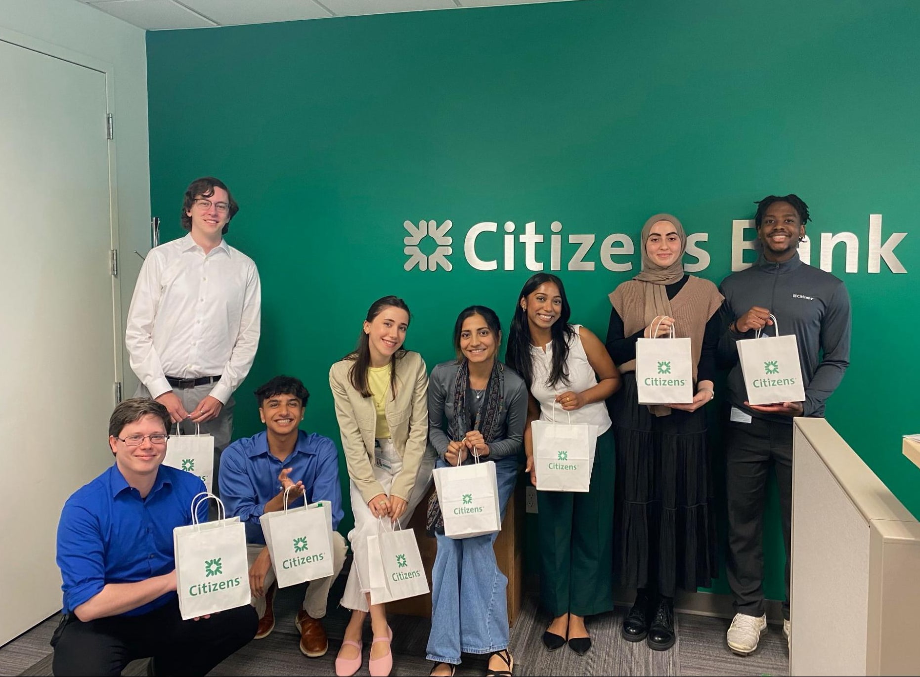 citizens-bank group of students in front of a Citizens Bank sign