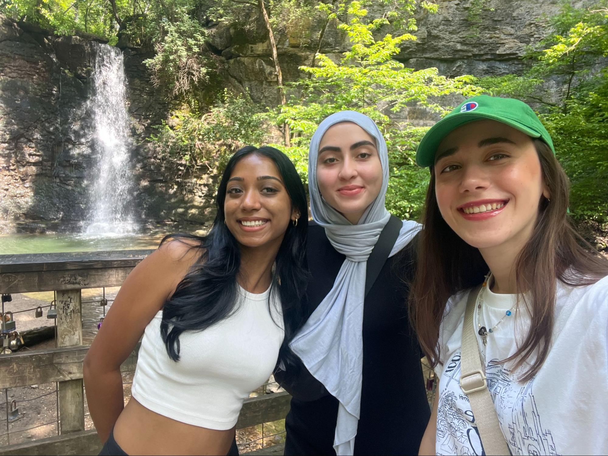 ria-elif-afag three students in front of a waterfall